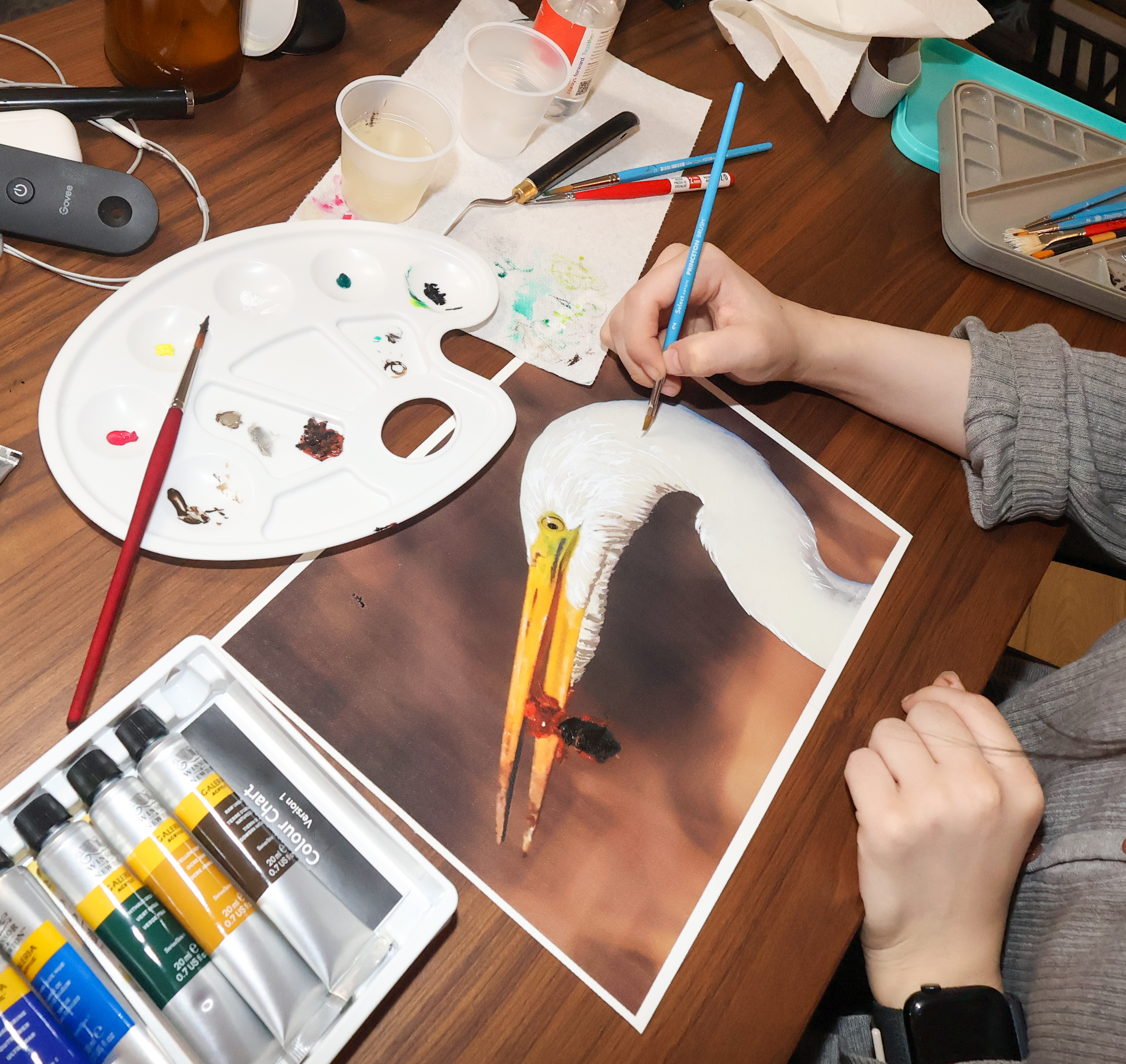 Artist painting on egret photo canvas